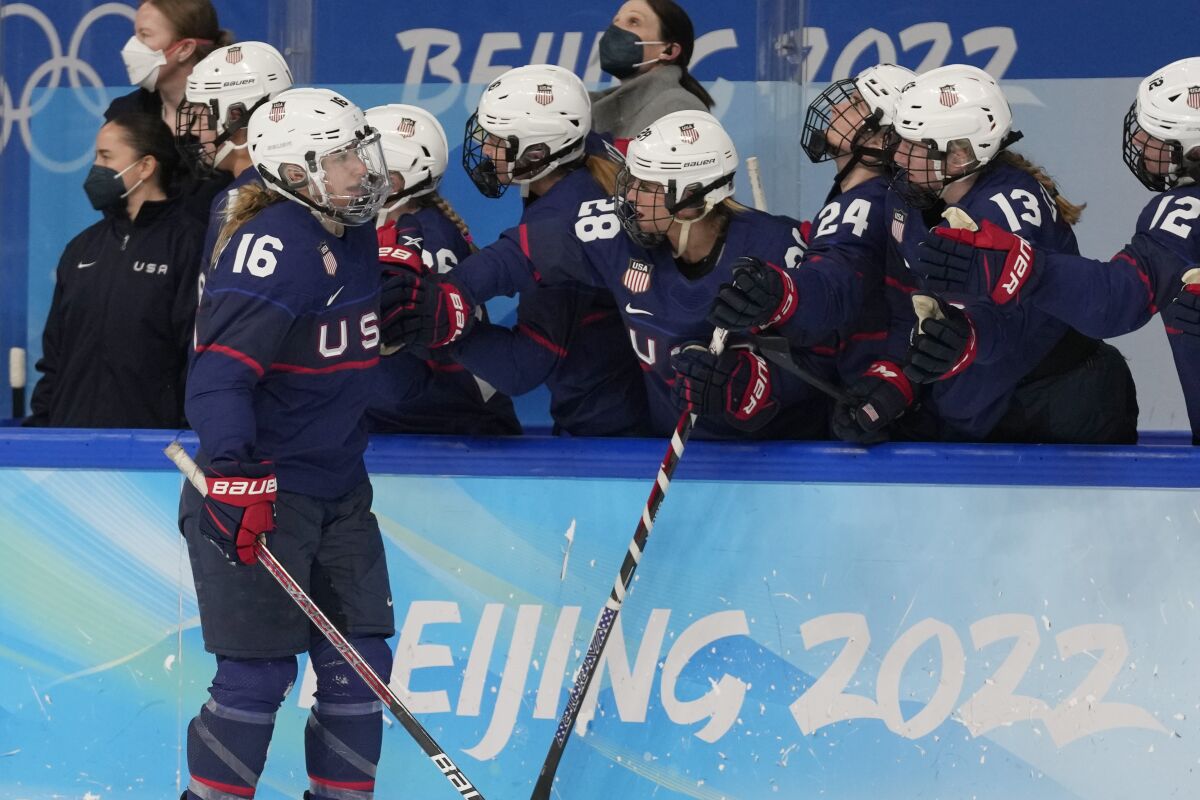 United States' Hayley Scamurra (16) is congratulated after scoring a goal against Finland during a women's semifinal hockey game at the 2022 Winter Olympics, Monday, Feb. 14, 2022, in Beijing. (AP Photo/Petr David Josek)