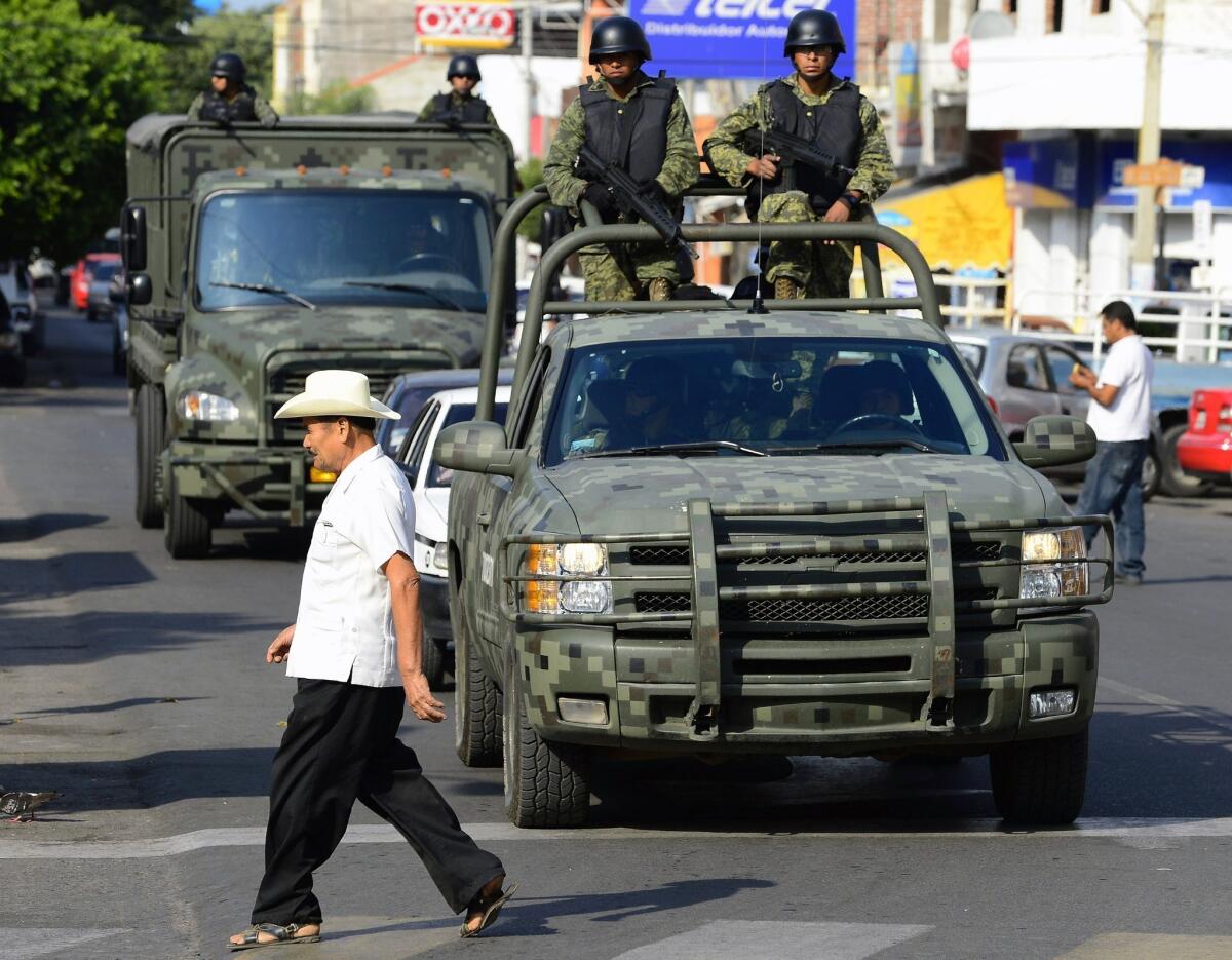 Mexican soldiers patrol the streets of Apatzingan, in Michoacan state.