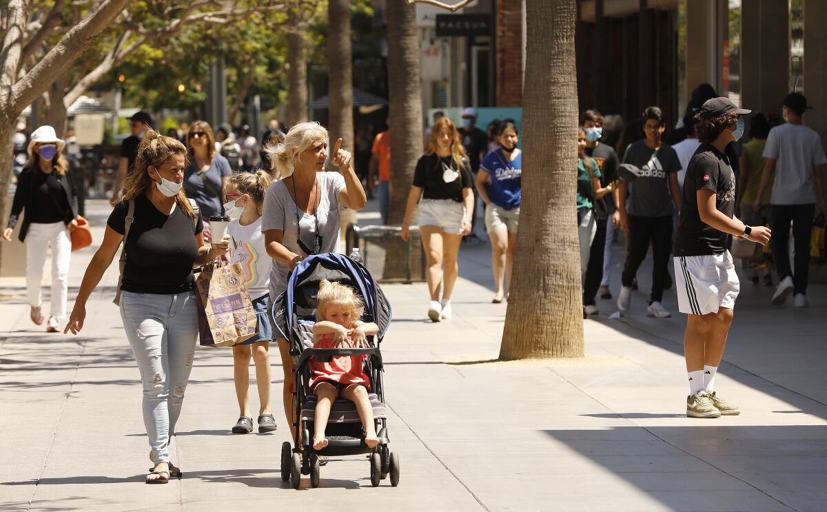 Pedestrians walk the Third Street Promenade in Santa Monica on Tuesday.