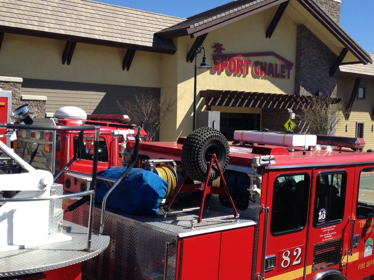 Fire crews respond to the Sport Chalet in La Canada, where authorities said an explosion hurt two employees.