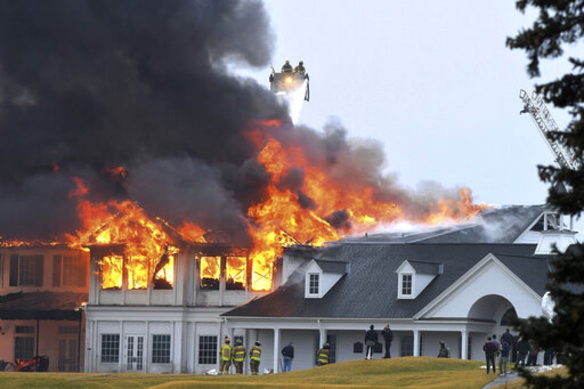 A fire burns at the main building at Oakland Hills Country Club in Bloomfield Township, Mich., on Thursday, Feb. 17, 2022. Firefighters battled a blaze at a more than century-old country club Thursday in suburban Detroit that's hosted several major golf tournaments and is one of Michigan’s most exclusive golf clubs.(Daniel Mears /Detroit News via AP)