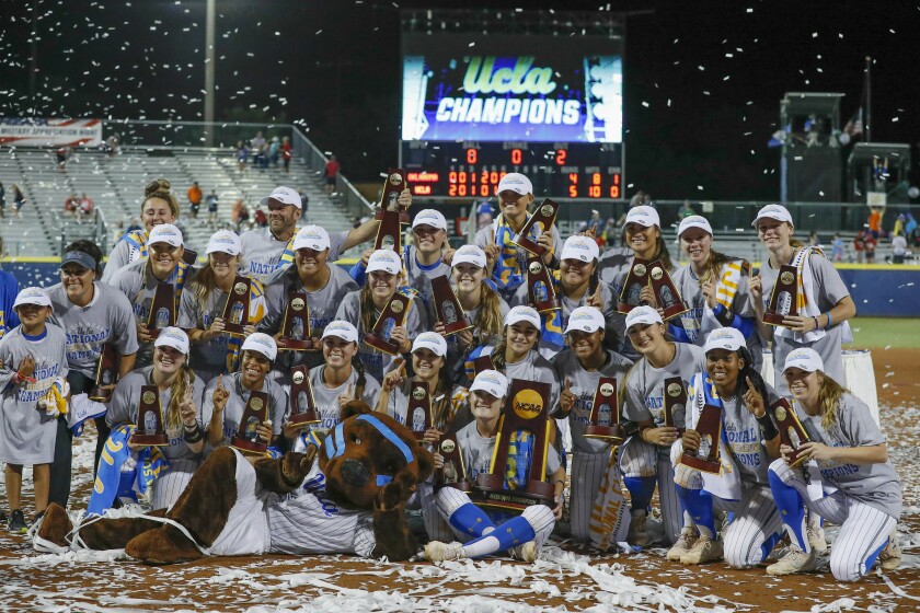 The UCLA softball team poses for pictures after defeating Oklahoma in the 2019 Women's College World Series in Oklahoma City.