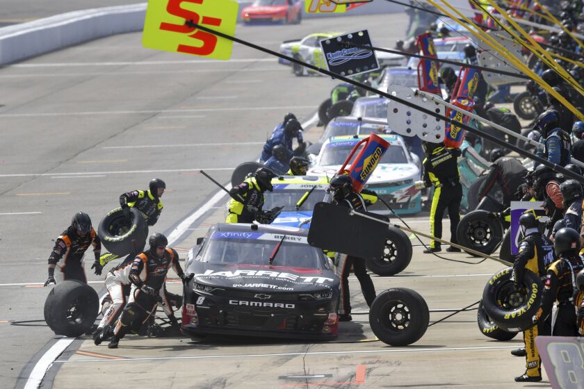 Josh Berry (8) stops for a pit stop during a NASCAR Xfinity Series auto race at Richmond Raceway on Saturday, April 1, 2023, in Richmond, Va. (AP Photo/Mike Caudill)