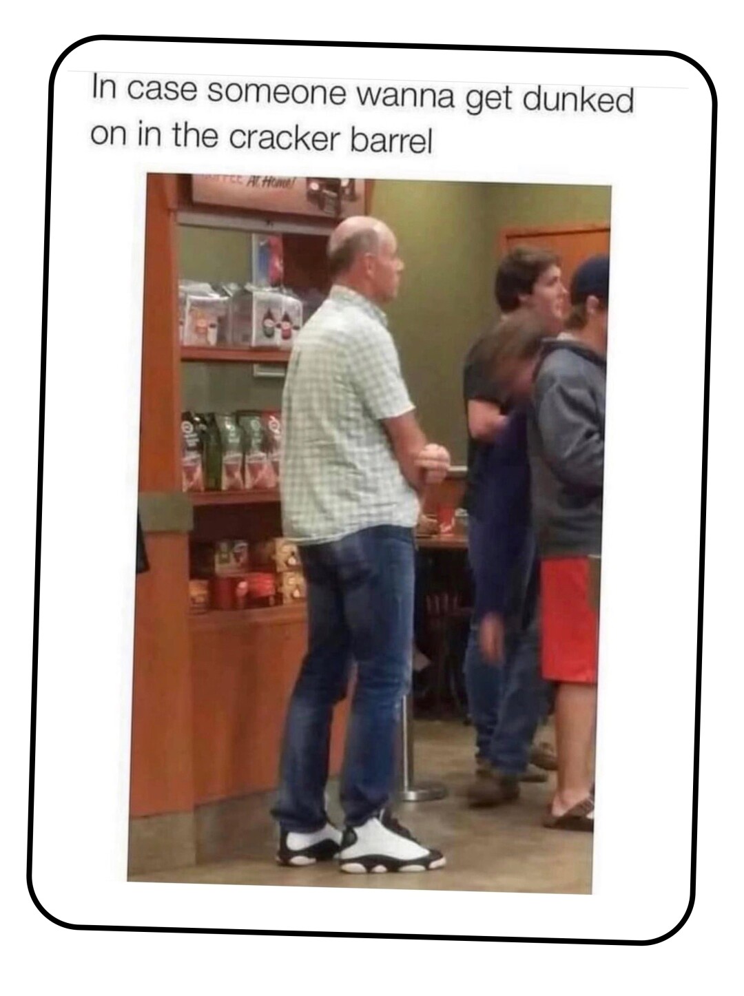 A picture of a middle aged guy in a drab collared shirt and blue jeans but with flashy basketball high tops.