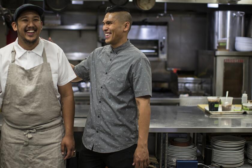 Chef Chad Valencia, left, and brother Chase Valencia in the kitchen at Lasa, a Filipino restaurant in Chinatown.