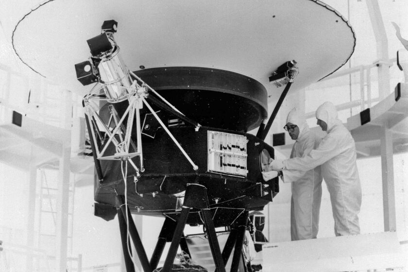 FILE - In this Aug. 4, 1977, photo provided by NASA, the "Sounds of Earth" record is mounted on the Voyager 2 spacecraft in the Safe-1 Building at the Kennedy Space Center, Fla., prior to encapsulation in the protective shroud. NASA is listening for any peep from Voyager 2 after losing contact with the spacecraft billions of miles away. (AP Photo/NASA, File)