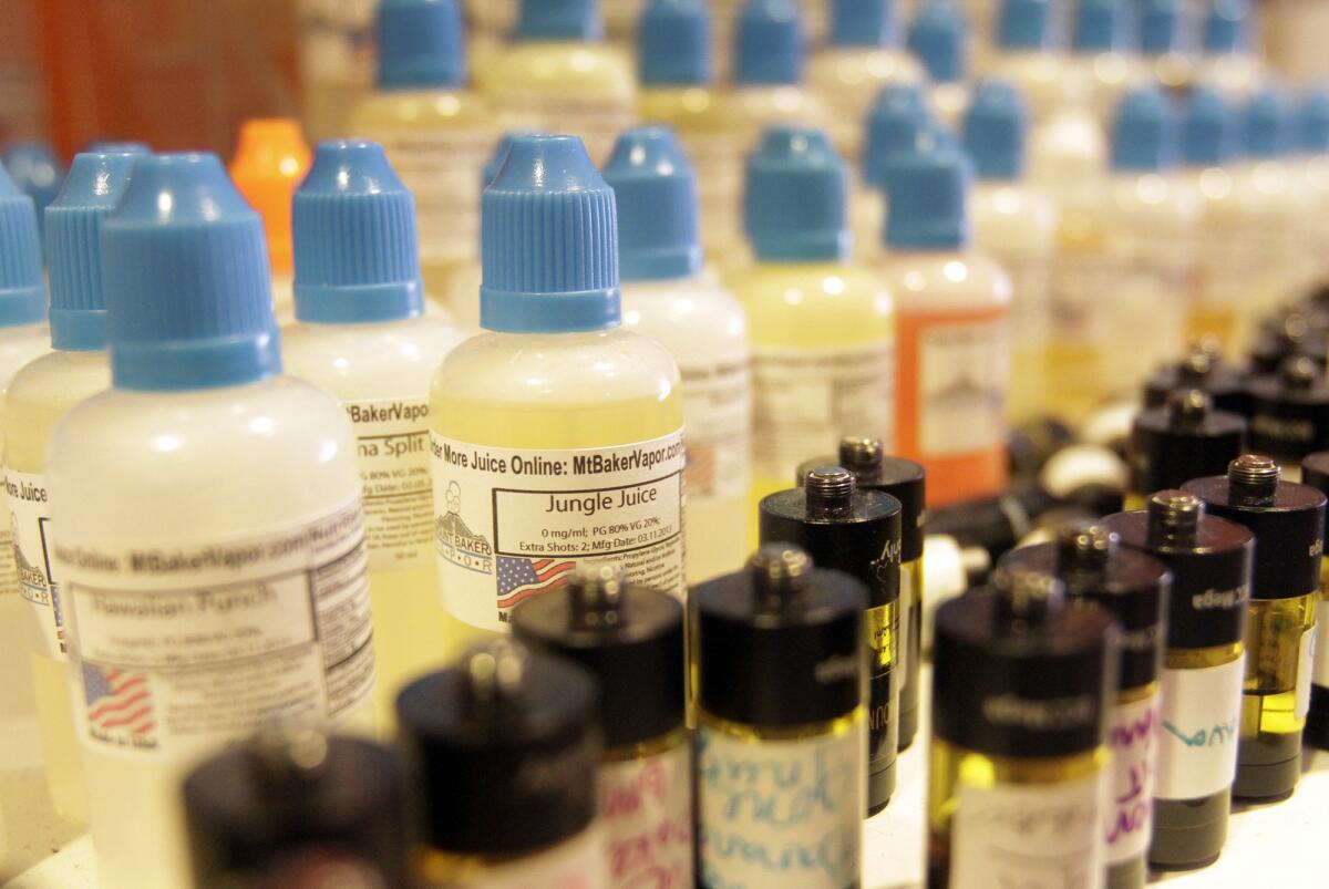 An array of flavored liquid for eCigs at The Vapor Spot in Westwood.