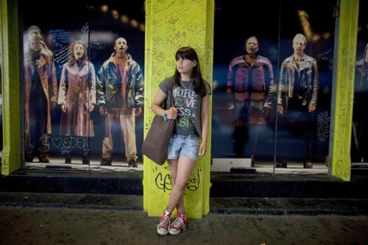 WILL WORK FOR 'RENT': Allison Theriault in front of the Nederlander Theatre, home of the Broadway musical "Rent": As the hit draws to a close after 12 years on Broadway, no one is mourning the show more than so-called Rentheads such as Theriault.