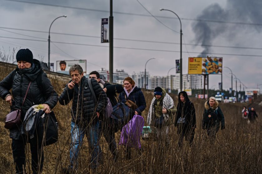 IRPIN, UKRAINE -- MARCH 6, 2022: Local residents evacuate as Russian forces advance and continue to bombard the town with artillery, in Irpin, Ukraine, Sunday, March 6, 2022. (MARCUS YAM / LOS ANGELES TIMES)