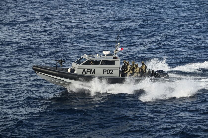 FILE - Members of the Maltese armed forces escort the catamaran carrying Pope Francis and leaving Valletta's harbor for Gozo in Malta Saturday, April 2, 2022. Rescue groups are accusing the European Island nation of Malta of coordinating the return of around 500 people to Libya where they were subsequently imprisoned, in violation of international maritime law. (Andreas Solaro/Pool via AP, File)