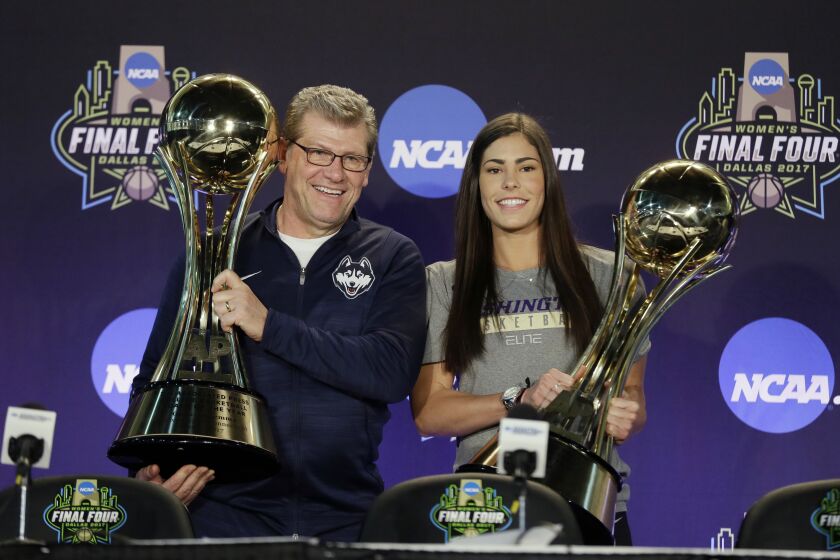 FILE - Connecticut head coach Geno Auriemma, left, and Washington's Kelsey Plum, right, hold their respective trophies after they were named The Associated Press Women's Basketball Coach of the Year and AP Women's Player of the Year at the women's NCAA Final Four college basketball tournament, Thursday, March 30, 2017, in Dallas. The Associated Press will announce the men’s and women's college basketball player and coach of the year awards this week. The women's awards will be announced on Thursday, March 30, 2023, the men's on Friday. (AP Photo/Tony Gutierrez, File)