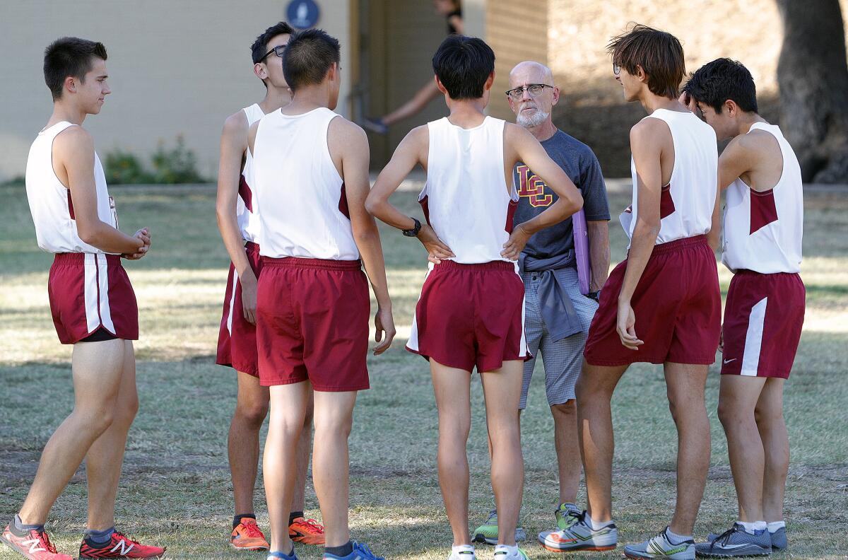 La Canada cross country coach Andy DiConti talks with his boys' team before the start of the boys' Rio Hondo League cross-country race at Crescenta Valley Regional Park on Tuesday, October 15, 2019.