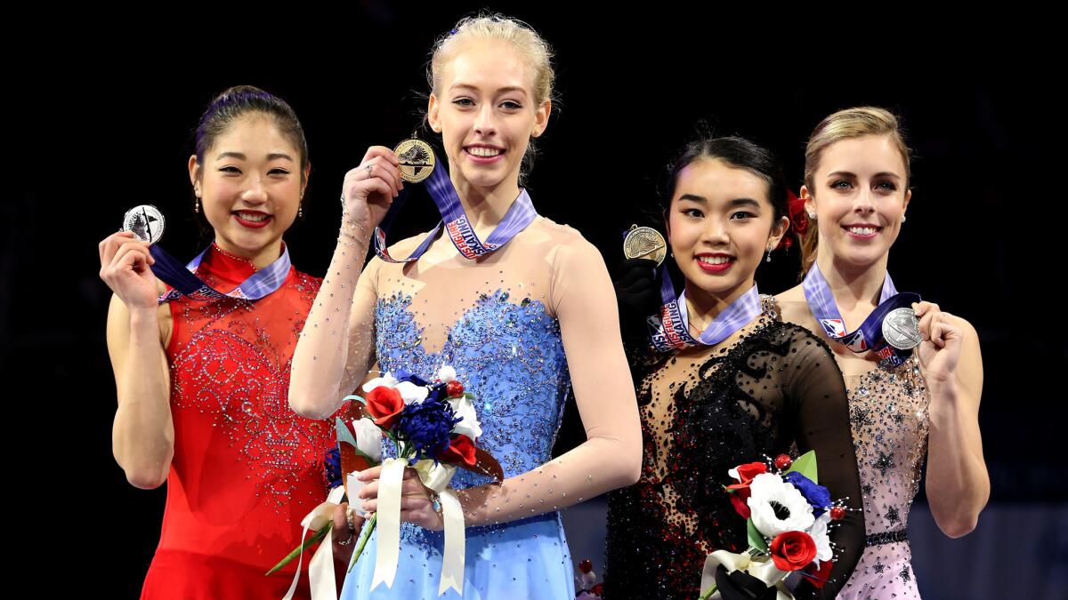 Bradie Tennell, in blue, is joined on the podium by, from left, silver medalist Mirai Nagasu, bronze medalist Karen Chen and fourth-place finisher Ashley Wagner at the U.S. figure skating championships on Friday night.