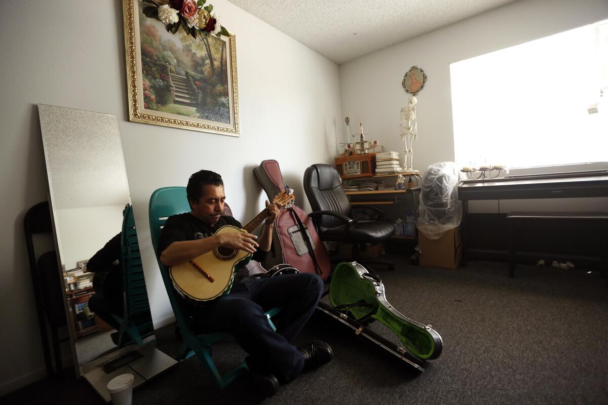 Mariachi performer Luis Valdivia practices in his apartment in Boyle Heights. Valdivia and his brother, Enrique, face eviction because they are unable to keep up with an 80% rise in rent.