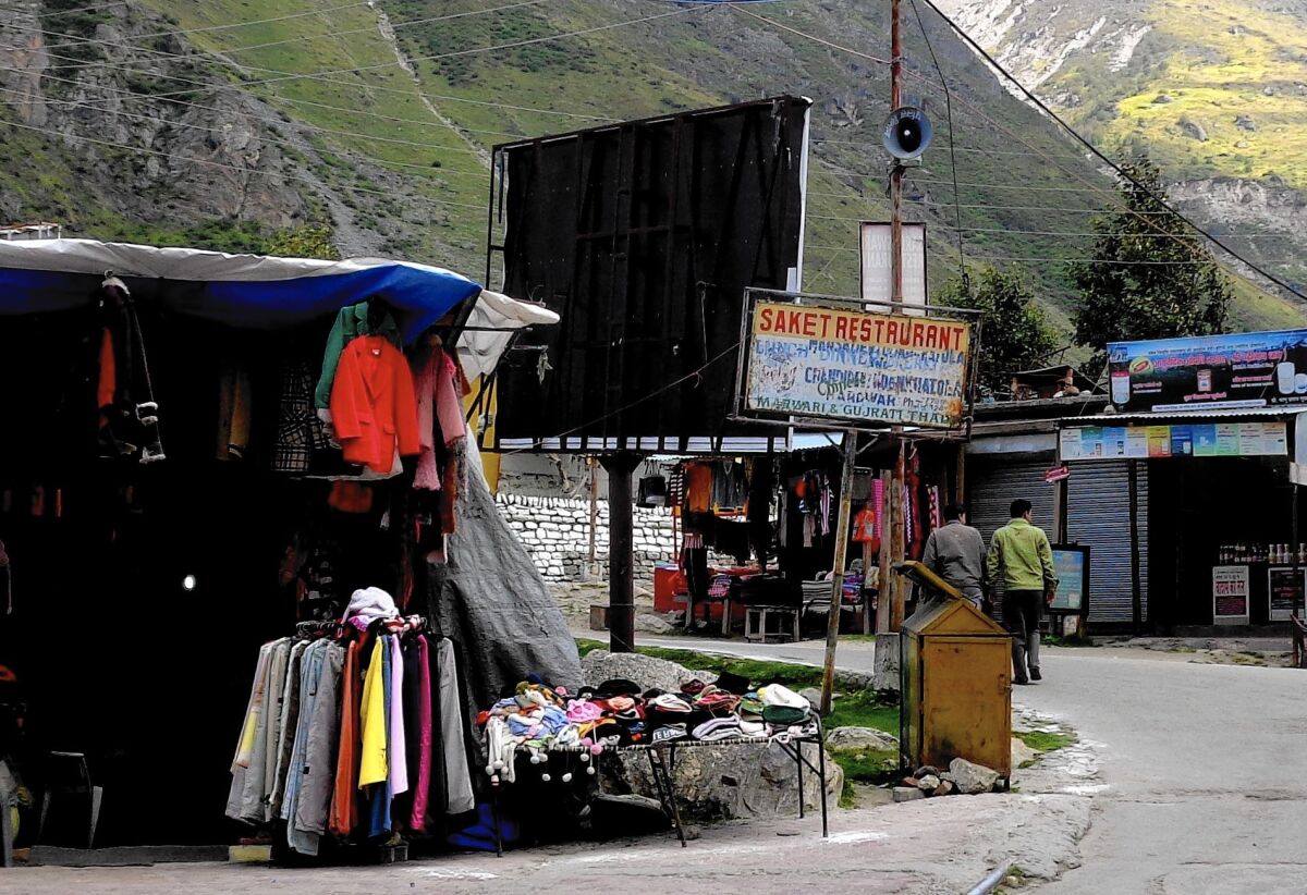 A vibrant display of woolen clothes in the empty market in Badrinath, India, in the shadow of the Himalayas. The normally busy temple town is all but deserted after devastating floods in the area last year killed thousands.