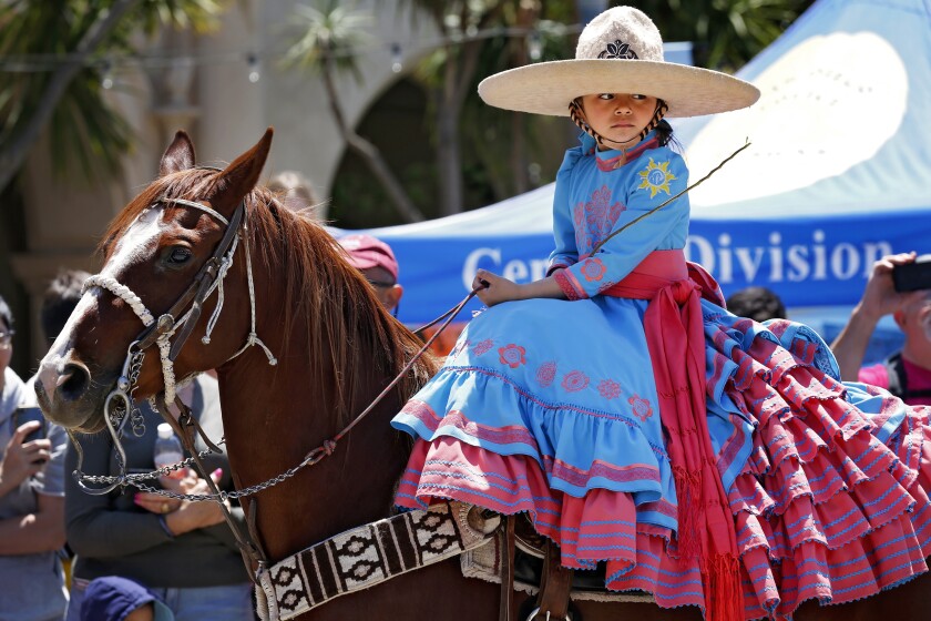 Valeria Perez, 6, with Charro de Escondido takes part in 2019's Cinco de Mayo celebration in Balboa Park.