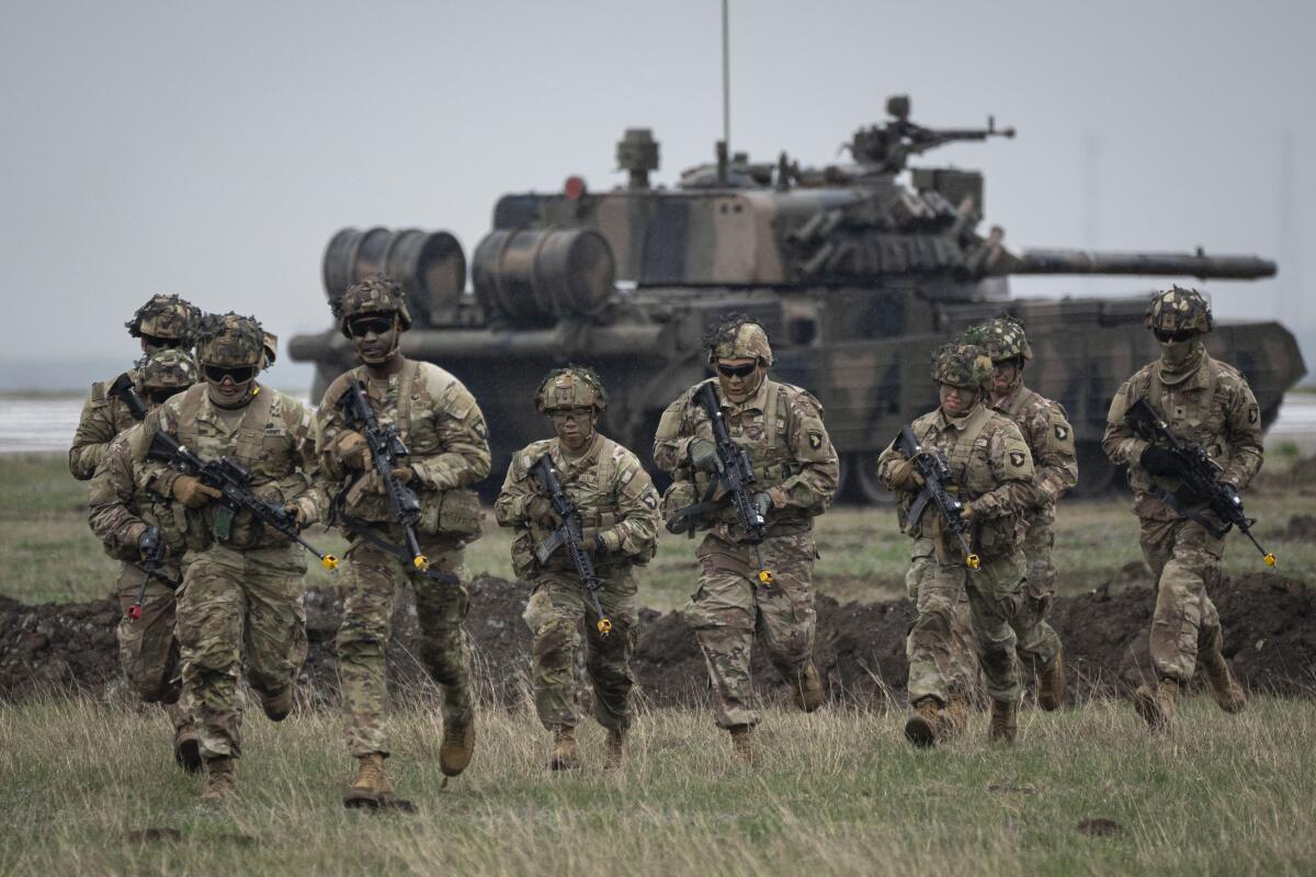 U.S. servicemen running during an exercise in Romania