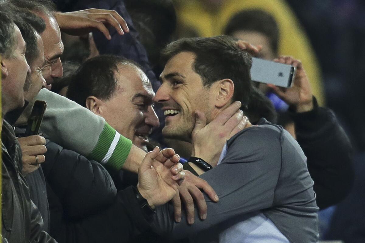 Porto goalkeeper Iker Casillas, center, celebrates with the supporters.