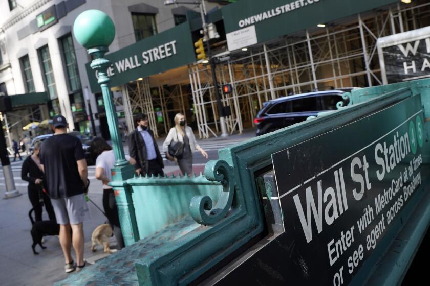 People walk on Broadway at Wall Street in New York. Stocks were falling Friday, Sept. 3,