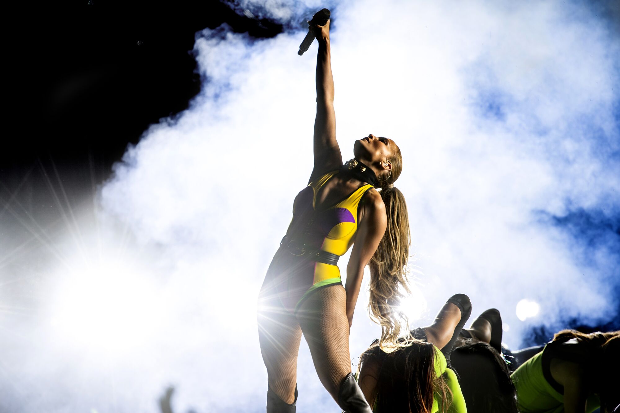 Jennifer Lopez raises her arm during the Vax Live concert at SoFi Stadium