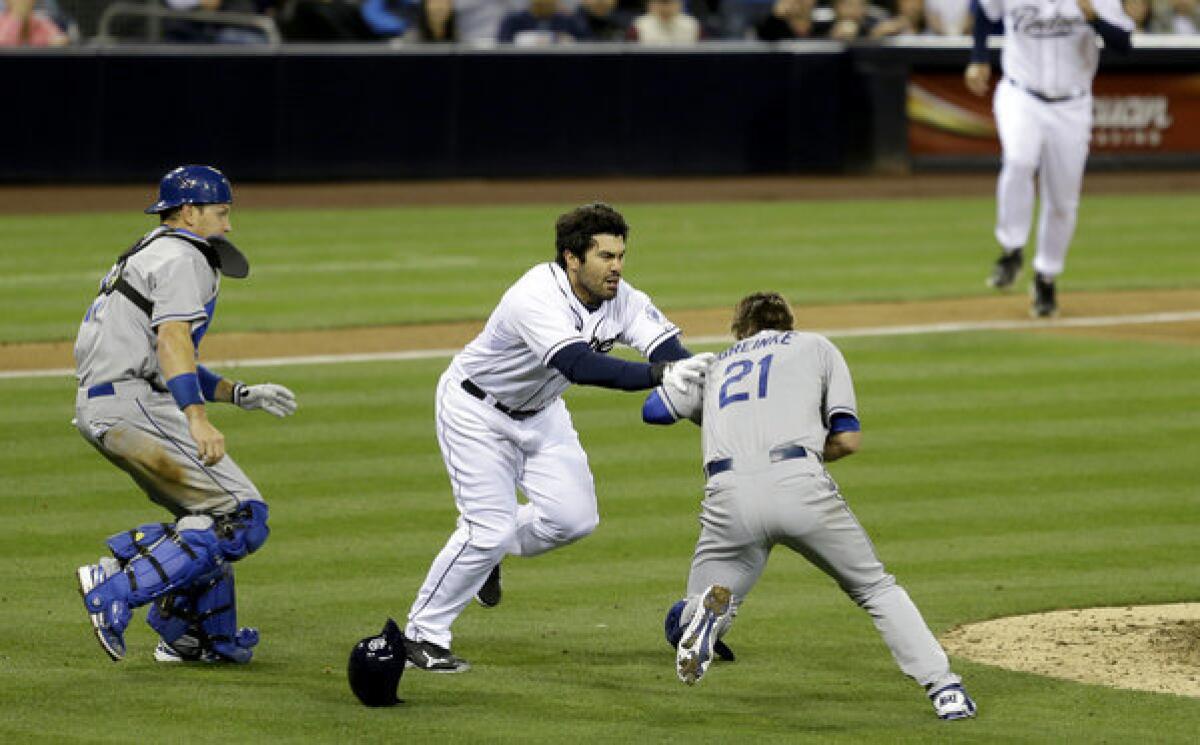 San Diego Padres' Carlos Quentin charges into Dodgers pitcher Zack Greinke after being hit by a pitch in April.