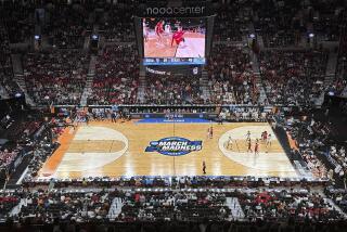 A full court, bird's eye view of Texas and North Carolina State playing during an Elite Eight college basketball game
