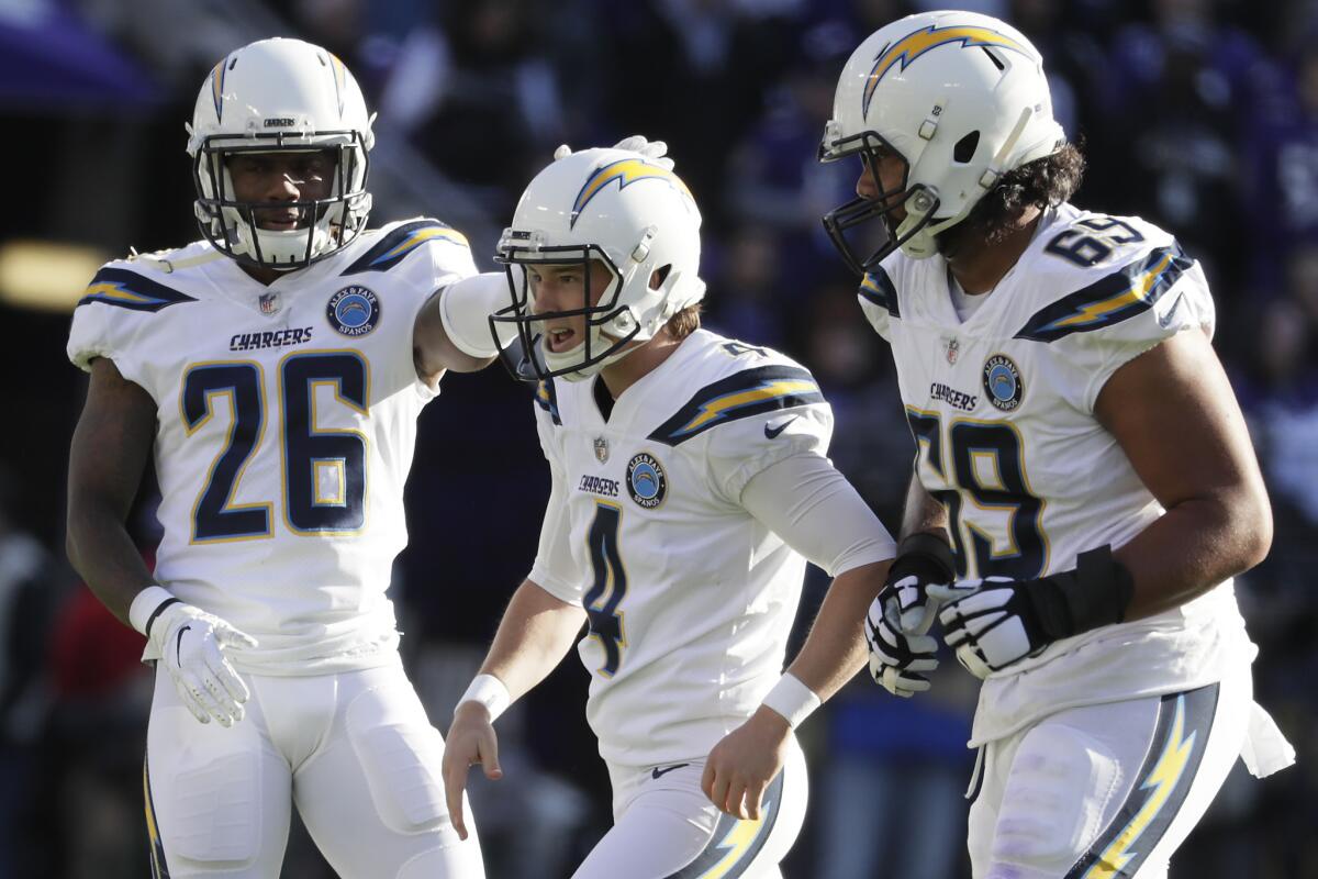 Chargers kicker Michael Badgley celebrates with teammates.