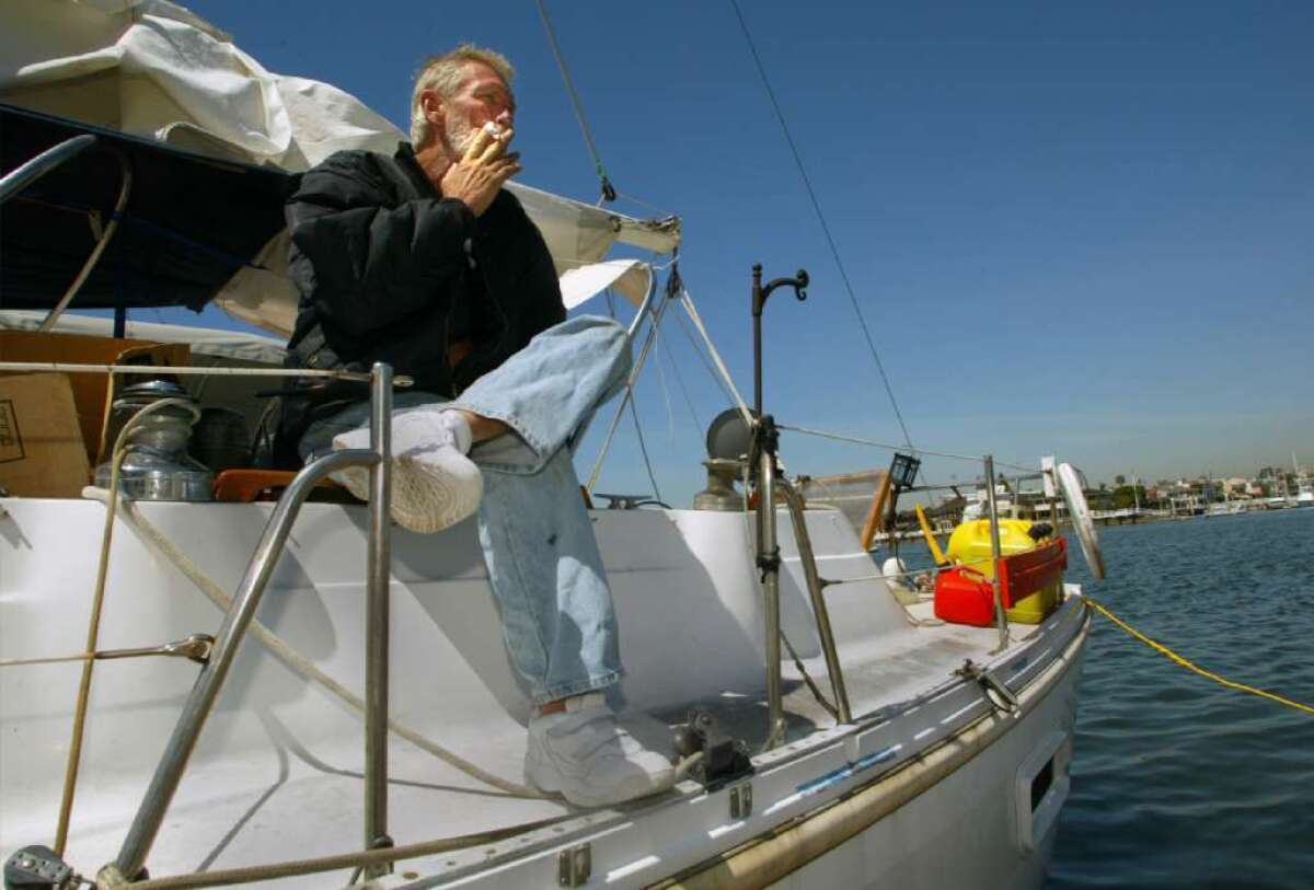 This cancer survivor smokes a cigarette on his boat in Newport Beach.