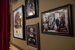 Photos of Pearl Harbor survivor Bob Fernandez, 100, hang on the wall at Whirlows in Stockton.