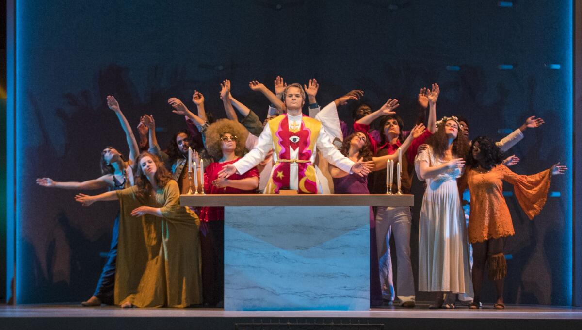 Ryan McKinny, center, who performs as the Celebrant, along with the Street Chorus and dancers in the Los Angeles Philharmonic production of Leonard Bernstein's 'Mass' at the Walt Disney Concert Hall Thursday.