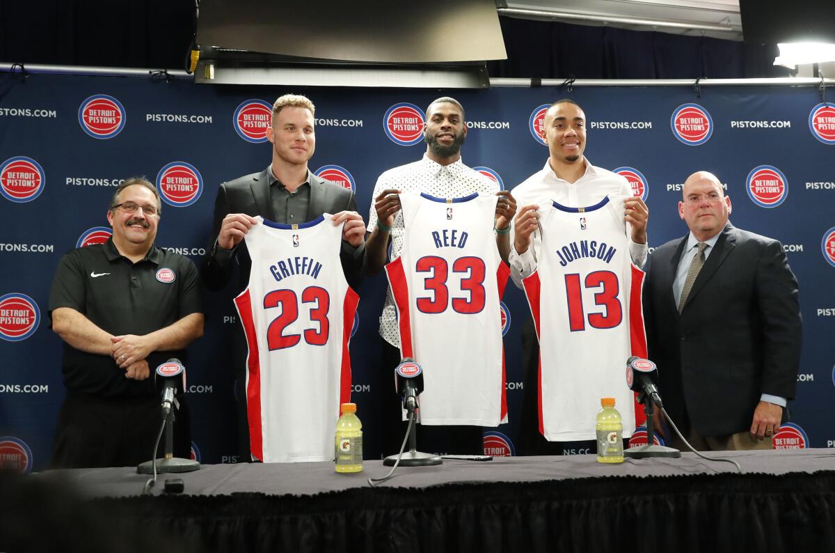 Detroit Pistons head coach Stan Van Gundy, from left, Blake Griffin, Willie Reed, Brice Johnson and General Manager Jeff Bower pose with their new NBA basketball uniforms in Auburn Hills, Mich., Wednesday, Jan. 31, 2018.