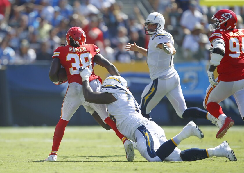 Chargers offensive tackle Russell Okung makes a tackle on the Chiefs' Ron Parker following an interception thrown by Philip Rivers.