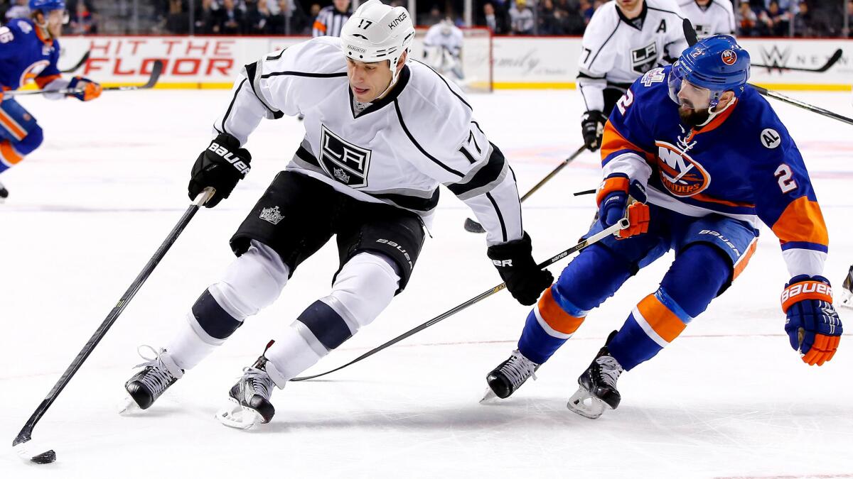 Kings left wing Milan Lucic tries to protect the puck from Islanders defenseman Nick Leddy during their game Thursday night at Barclays Center.