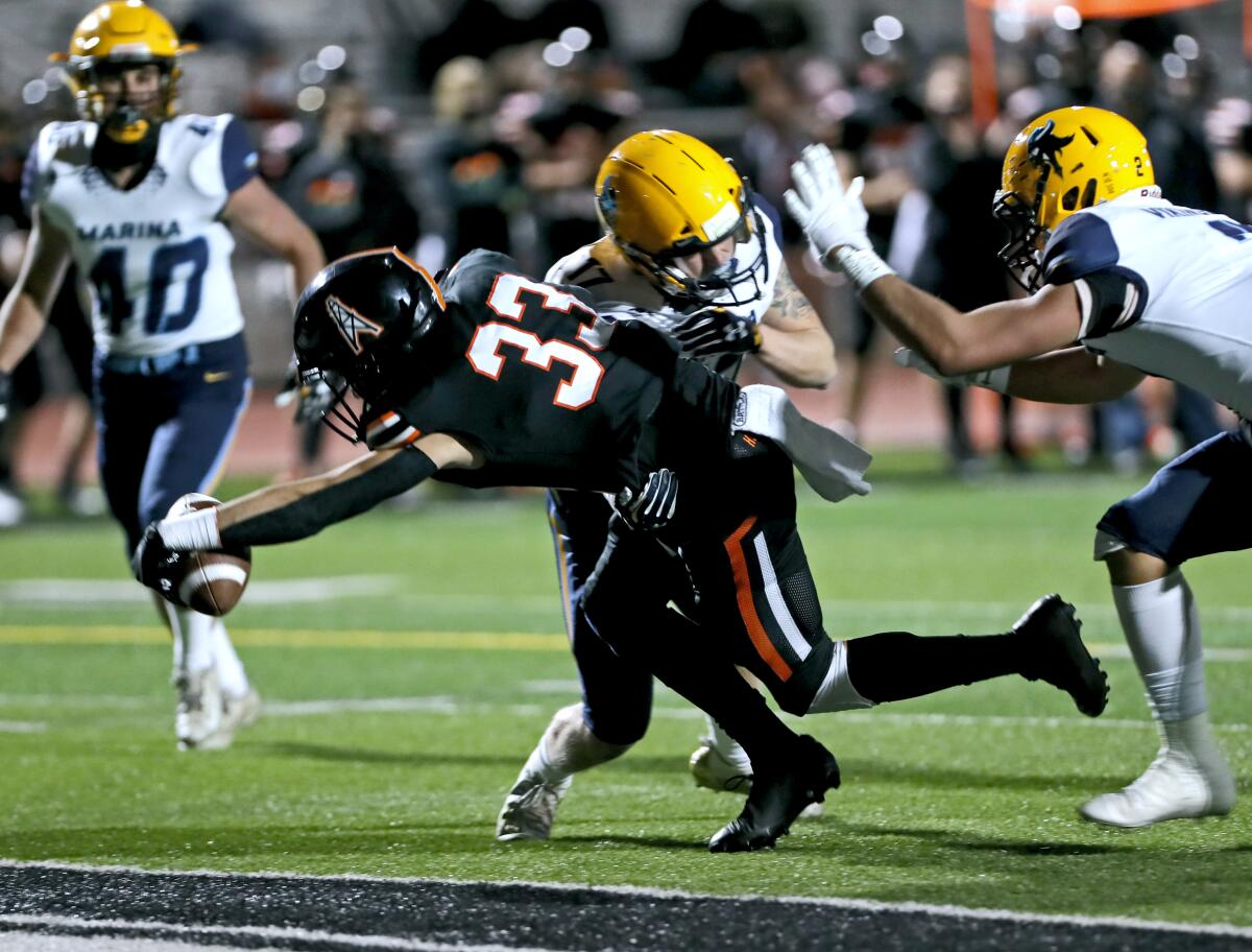Huntington Beach wide receiver Jonah Del Rosario dives in for a touchdown.