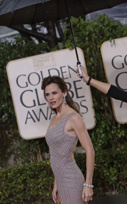 Jennifer Garner's beaded Versace gown had the mom of two glowing like a goddess on the red carpet. With the neutral tone and simple silhouette of her dress, makeup artist Kate Lee and hair stylist Adir Abergel worked their magic in order for the gown to come alive rather than drown the actress out in a heavy drape of silver-taupe fabric. -- Melissa Magsaysay