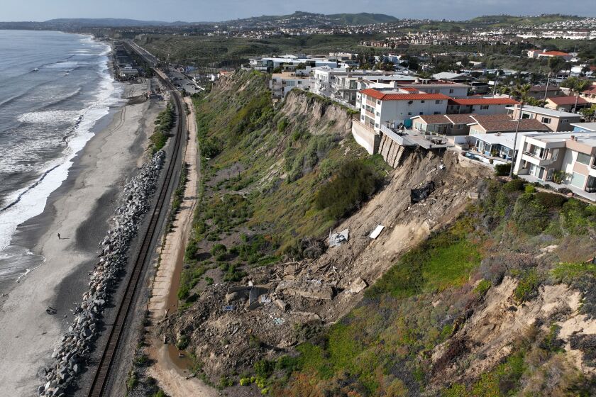 San Clemente, CA - March 16: Aerial view of four cliff-side, ocean-view apartment buildings that were evacuated and red tagged after heavy rains brought on a landslide that left the rear of the buildings in danger of tumbling down the cliff on Buena Vista in San Clemente Thursday, March 16, 2023. (Allen J. Schaben / Los Angeles Times)