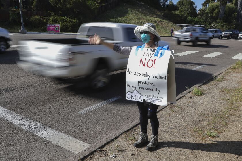 LA MESA, CA - APRIL 06: Local resident Marty Ornish carries a sign against the proposed placement of sexually violent predator Douglas Badger while protesting at the corner of Avocado Blvd. and Fuerte Drive on Tuesday, April 6, 2021 in La Mesa, CA. (Eduardo Contreras / The San Diego Union-Tribune)