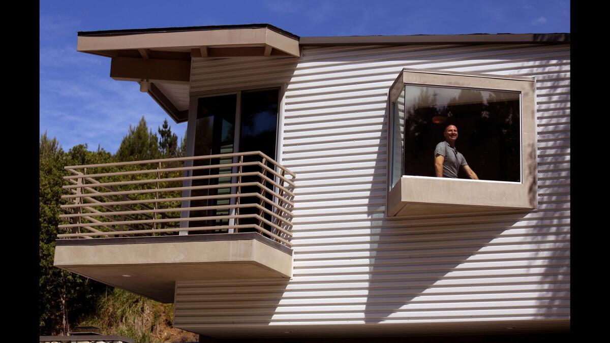 Todd Conversano's master bedroom addition is built upon a framework that doesn't actually connect with the original home, other than through a staircase hidden within the aluminum siding. From outside, though, it appears to float above the house as a second story.