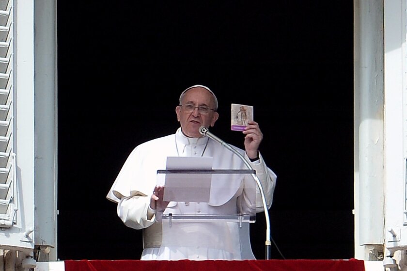 Pope Francis, shown holding a book titled "Take Care of Your Heart" on Feb. 22 during prayers Sunday at the Vatican, drew a rebuke from Mexico this week over an emailed comment about drug trafficking.