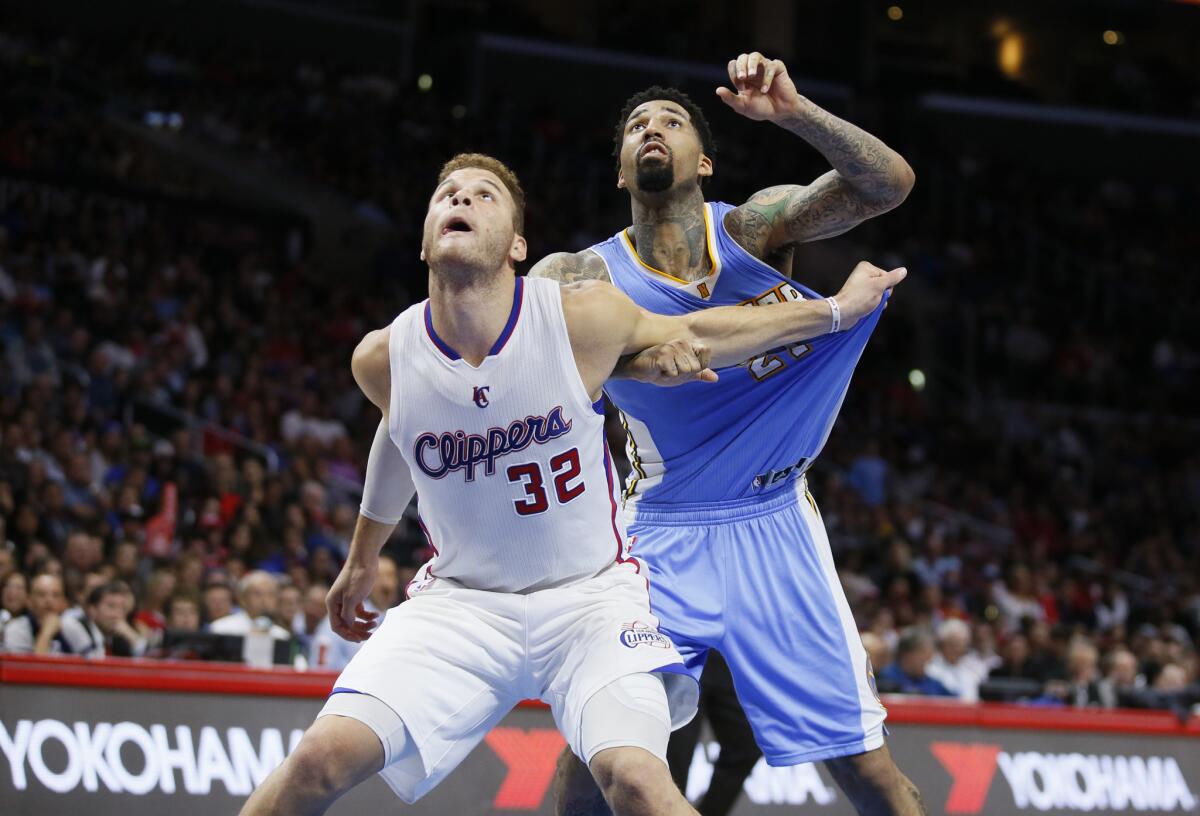 Blake Griffin and Denver forward Wilson Chandler battle for position during the second half of the Clippers' 110-103 victory over the Nuggets on Monday at Staples Center.