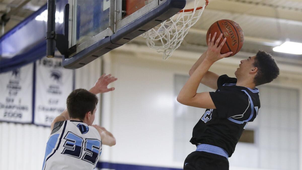 Corona del Mar High's Kevin Kobrine goes up for a shot against University's Will Stenta during a Pacific Coast League opener on Tuesday. Kobrine finished with 37 points on 15-for-22 shooting to go with 27 rebounds.