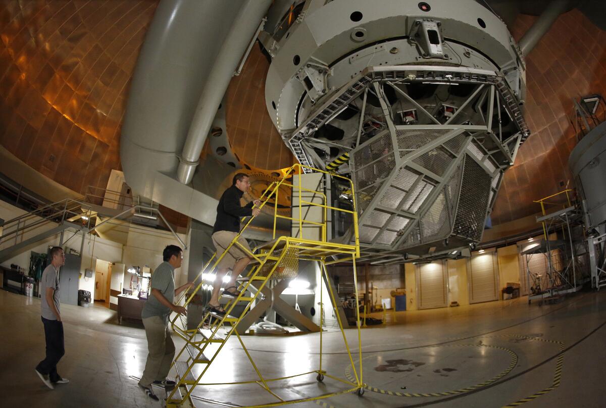 Caltech astronomer Mike Brown leads students Patrick Fischer, left, and Ian Wong, center on a tour of the Hale telescope.