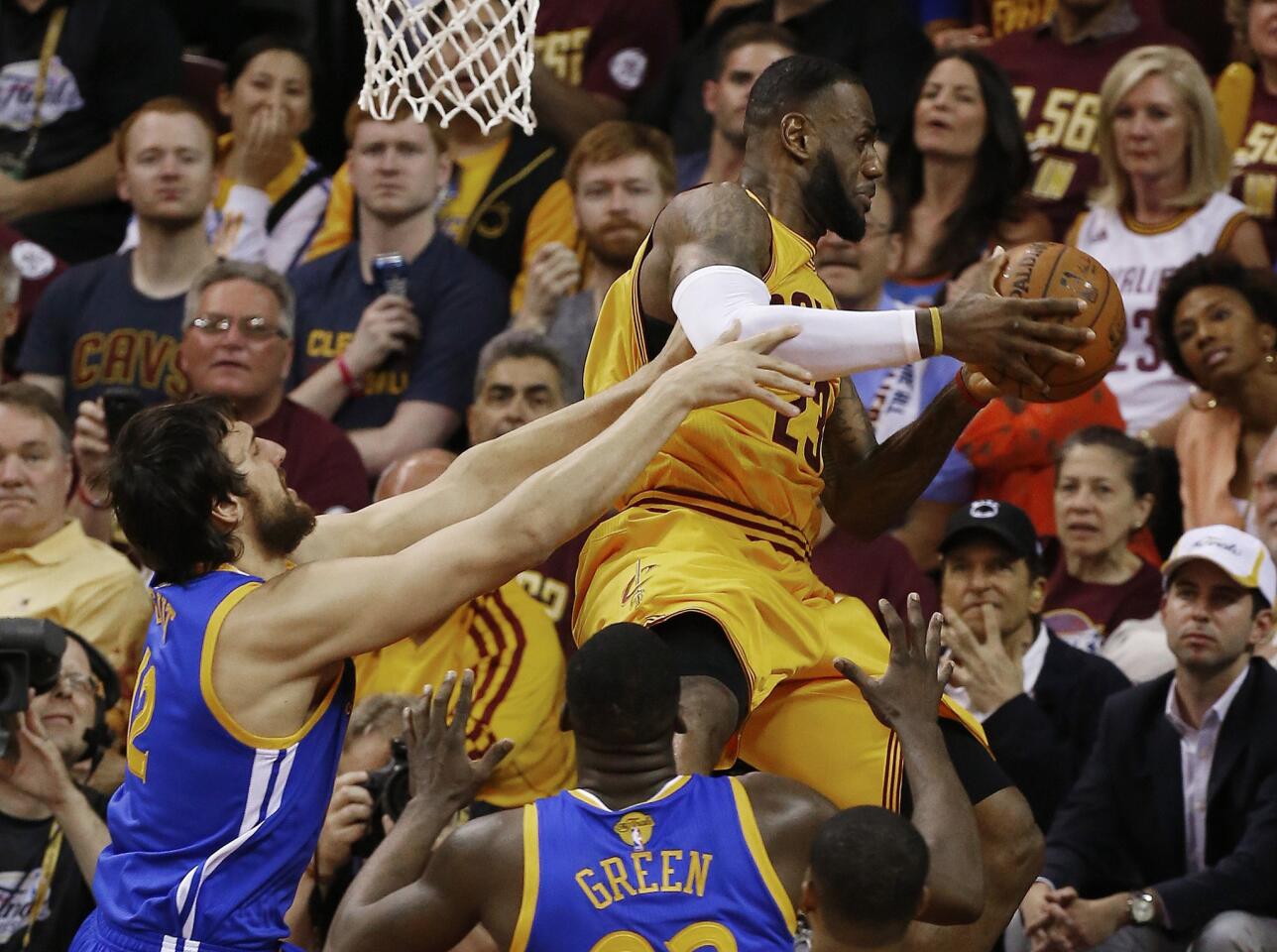 Cavaliers forward LeBron James is knocked out of the air, and sent tumbling out of bounds, by Warriors center Andrew Bogut, who was called for a foul on the play that left James with a bloody head.