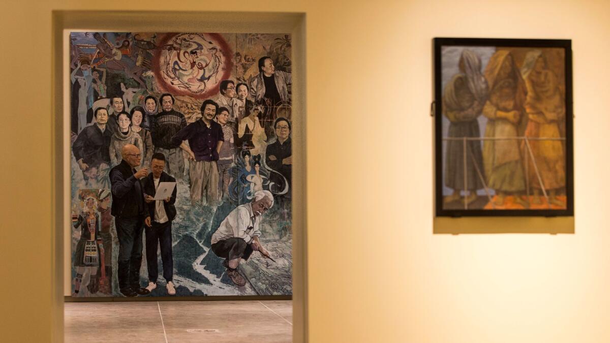A mural in the exhibition "Winds From Fusang: Mexico and China in the Twentieth Century" appears through a door way in the recently renovated USC Pacific Asia Museum in Pasadena. The museum reopens Friday.