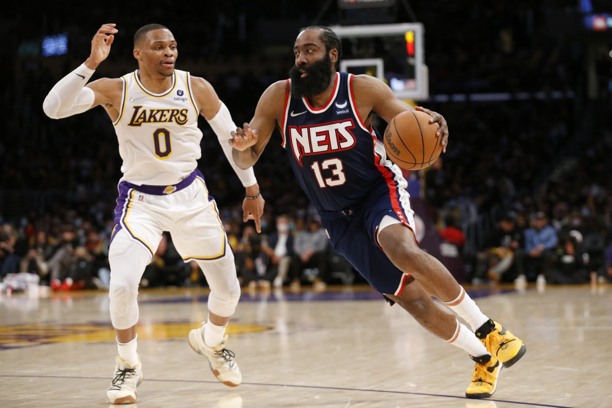 Lakers guard Russell Westbrook, left, tries to stay in front of Brooklyn Nets guard James Harden during the second half.