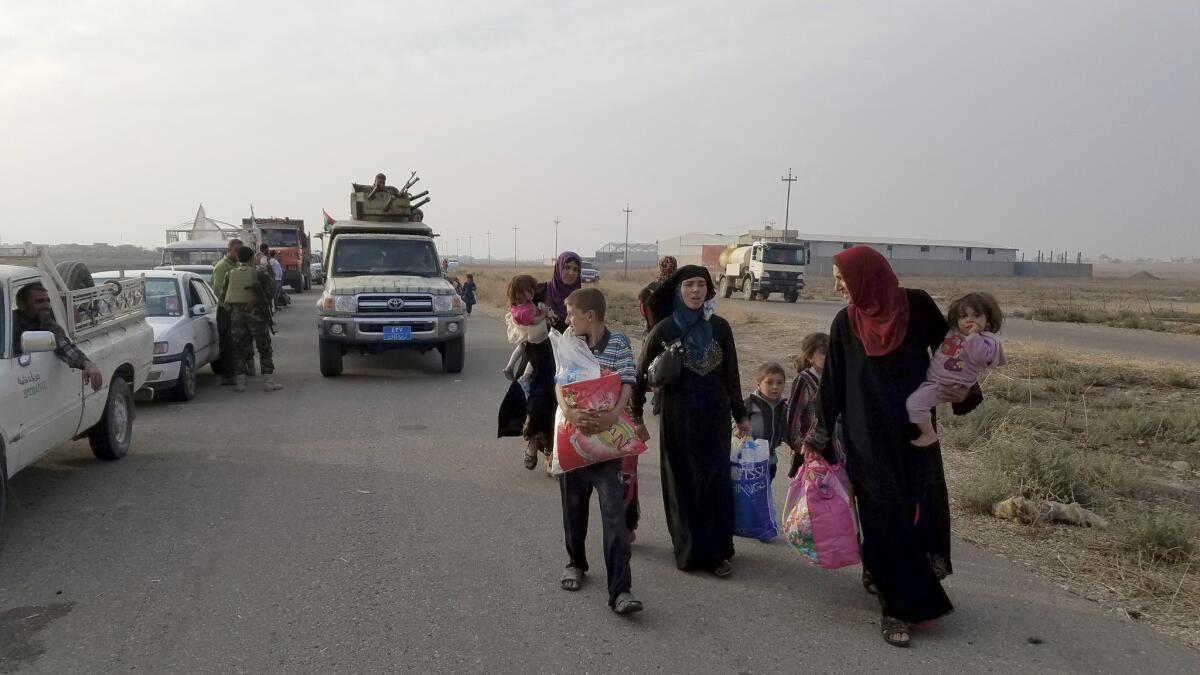 Soldiers separated women and children from men fleeing the village of Tob Zawa after they were freed from Islamic State. Women and children were sent to a displaced persons camp while men and youth were held for further screening.