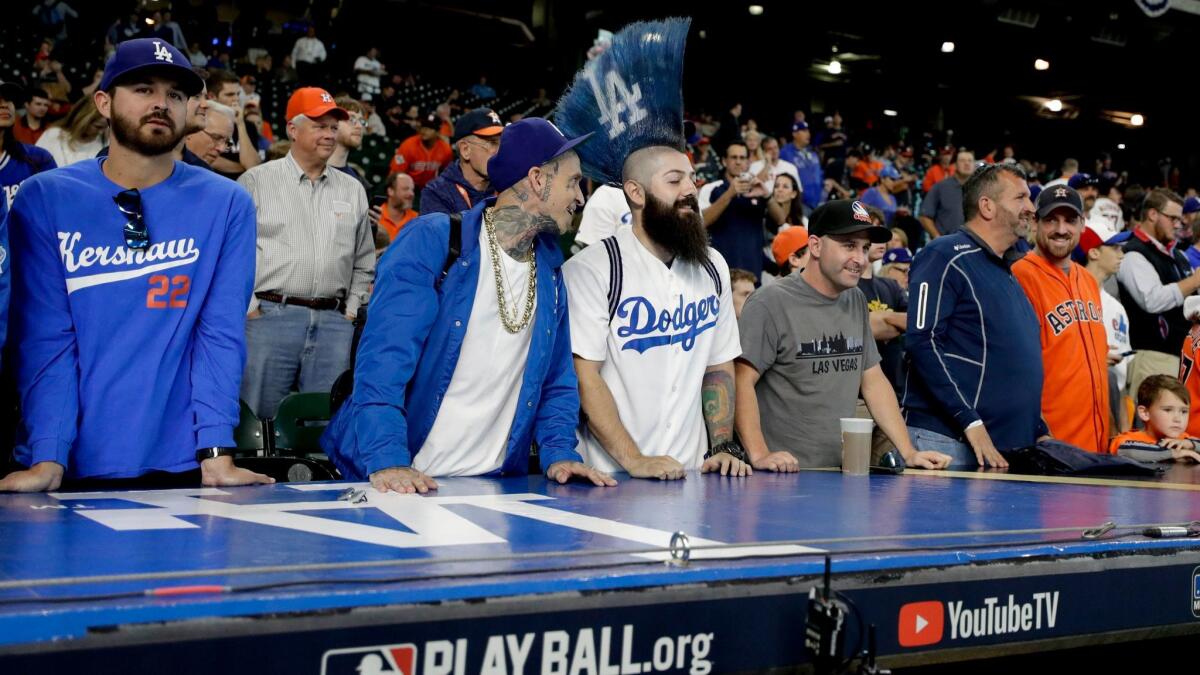 Fans watch batting practice before Game 5 of baseball's World Series between the Dodgers and the Astros in Houston.