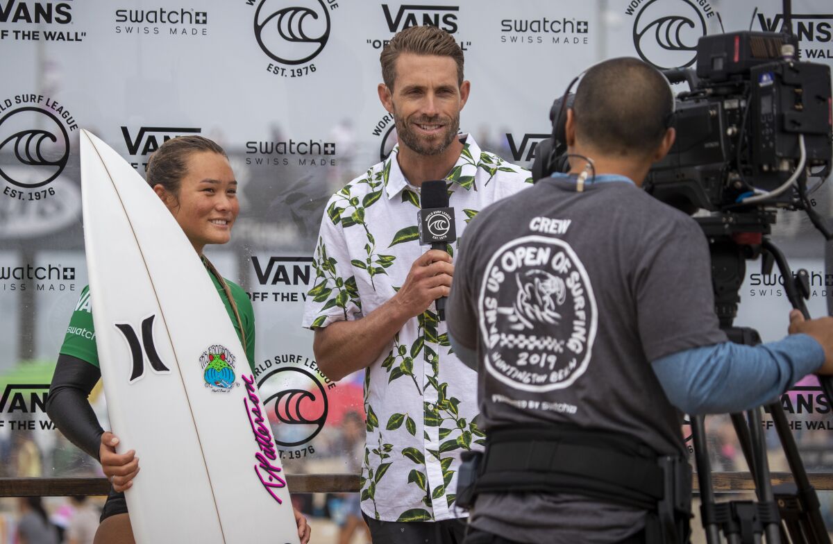 World Surf League broadcast commentator Ian Foulke, center, interviews surfer Meah Collins.