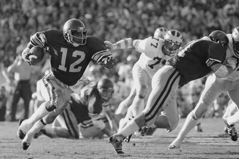 FILE - Southern California tailback Charles White carries against Michigan during the Rose Bowl NCAA college football game in Pasadena, Calif., Jan. 1, 1979. White died Wednesday, Jan. 11, 2023. He was 64. USC announced the death of White, who is still the Trojans' career rushing leader with 6,245 yards. The nine-year NFL veteran died of cancer, the school said. (AP Photo, File)