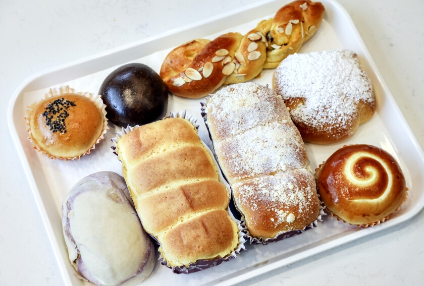 Among the light, fluffy and not too sweet treats from 85°C Bakery Cafe at Westfield UTC are (clockwise from top left) the red bean bread, choco bun, coconut twist, premium milk bun, milk pudding bread, sugar cream loaf, brioche and marble taro loaf. 